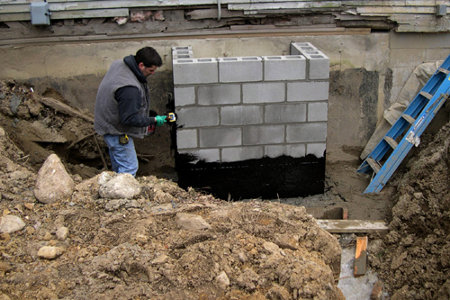 Scotty applying waterproofing